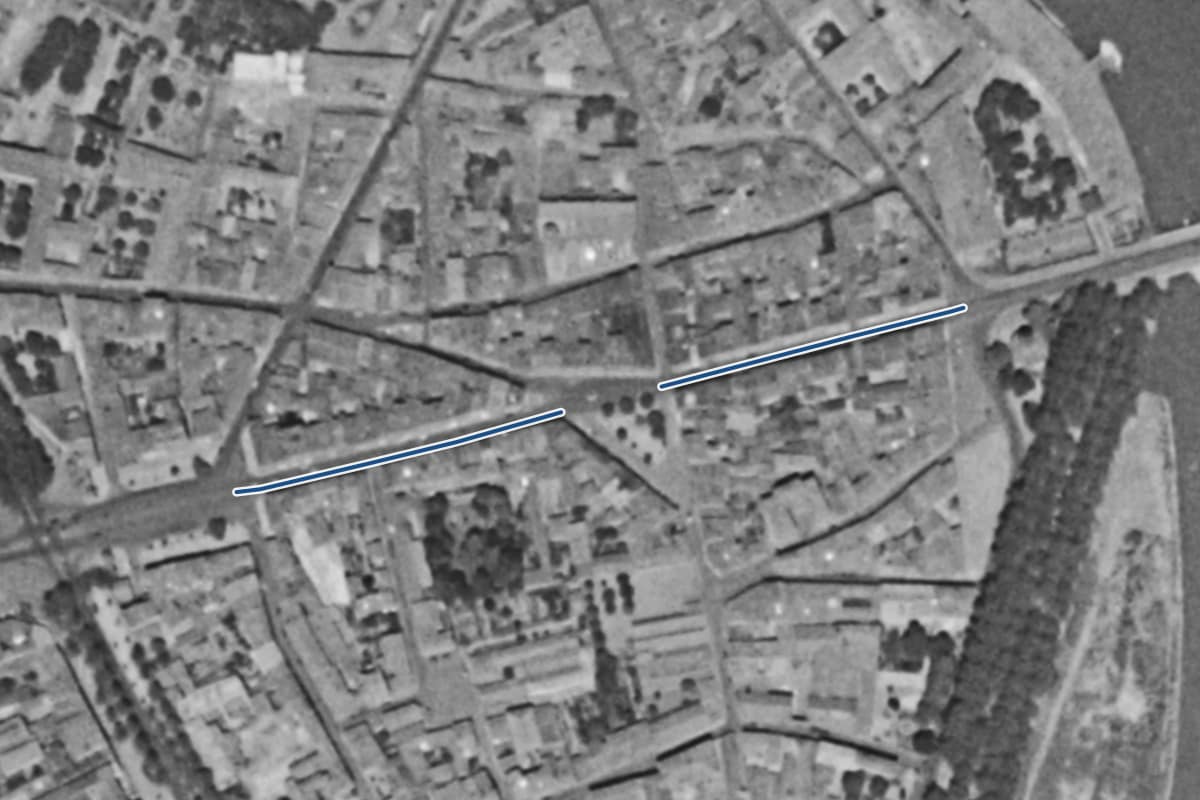 Vue aérienne de la rue de la République en 1954, en noir et blanc, la voie tracée en bleu